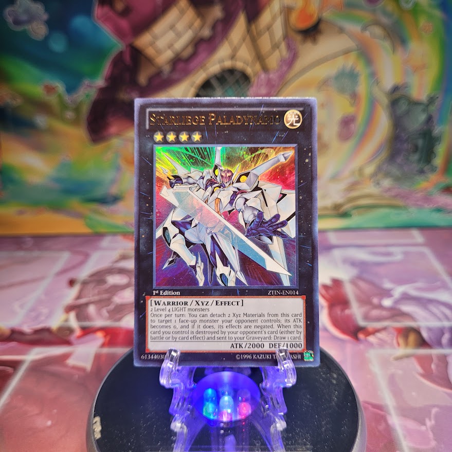 A 1st edition Ultra Rare "Starliege Paladynamo" card from the Yugioh Set: Zexal Collection Tin.