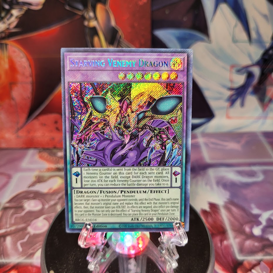 A Secret Rare "Starving Venemy Dragon" card from the Yugioh Set: Brothers of Legend (BROL).