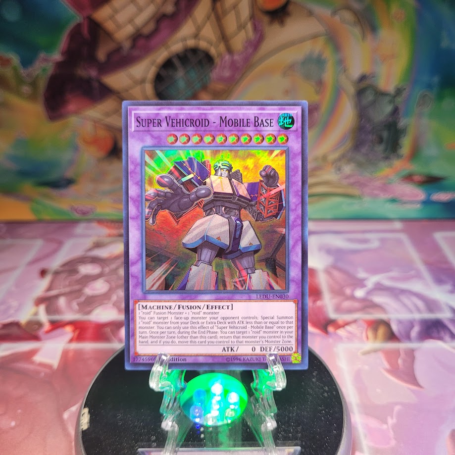 A Super Rare "Super Vehicroid - Mobile Base" card from the Yugioh Set: Legendary Duelists.