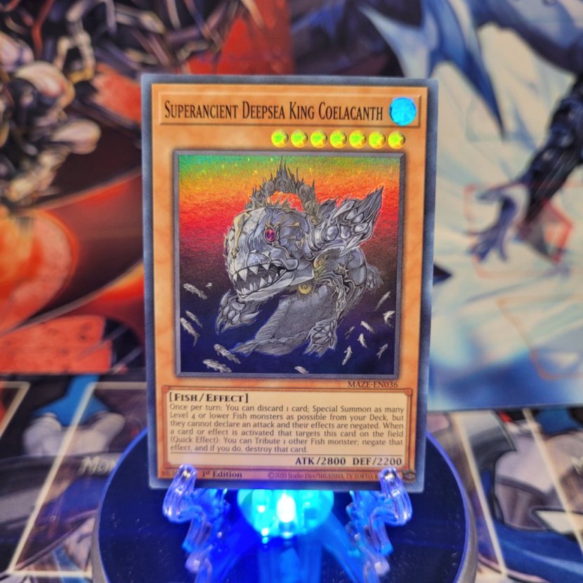 A Super Rare "Superancient Deepsea King Coelacanth" card from the Yugioh Set: Maze of Memories.