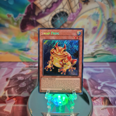 A Secret Rare "Swap Frog" card from the Yugioh Set: Quarter Century Bonanza (RA03).