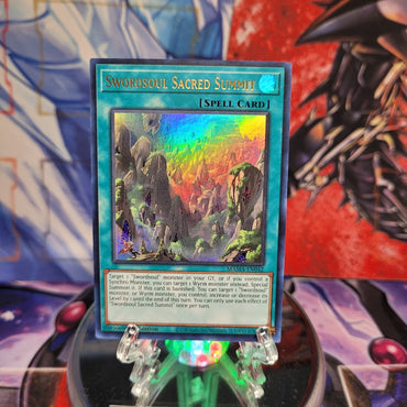 An Ultra Rare "Swordsoul Sacred Summit" card from the Yugioh Set: Magnificent Mavens.