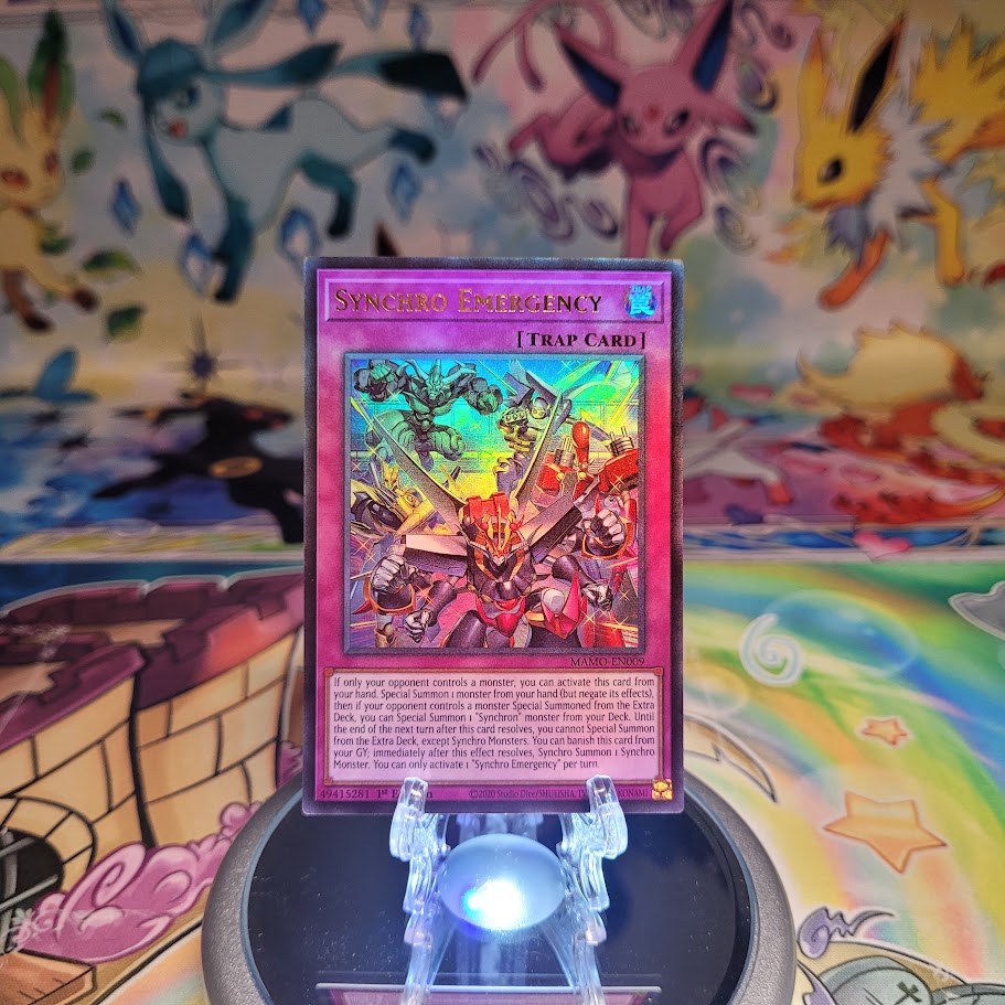 An Ultra Rare "Synchro Emergency" card from the Yugioh Set: Magnificent Monsters (MAMO).