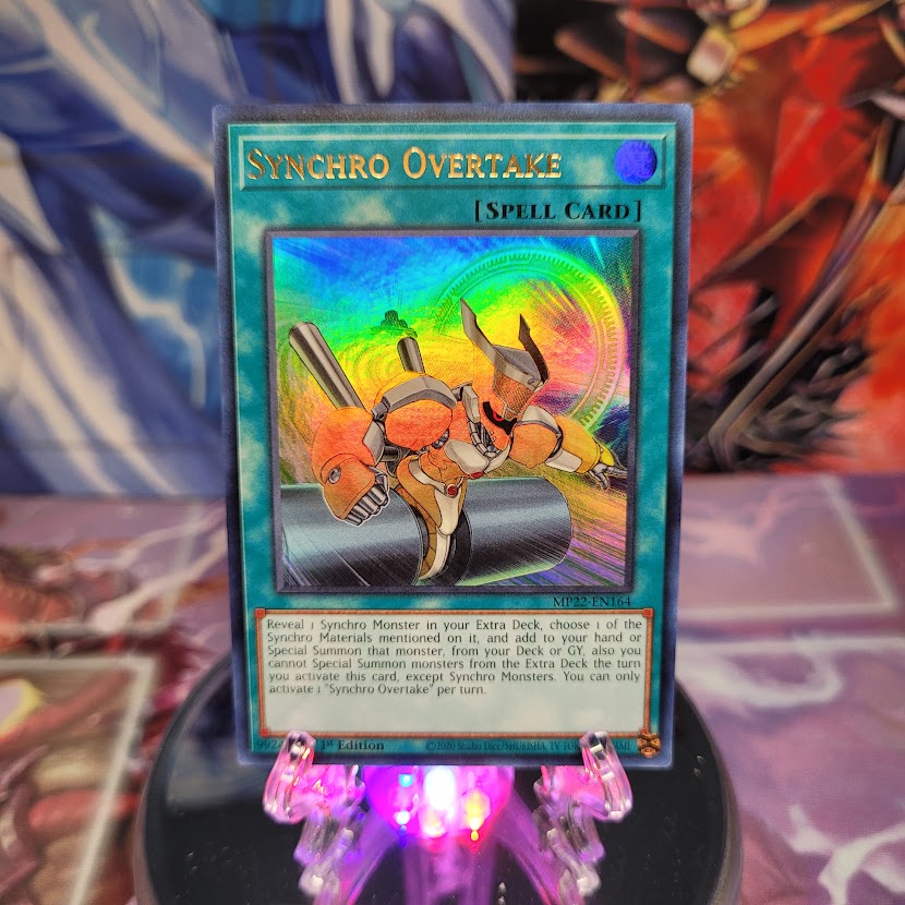 An Ultra Rare "Synchro Overtake" card from the Yugioh 2022 Tin of the Pharaoh's Gods Set.