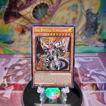 A Prismatic Secret Rare "The Bystial Lubellion" card from the Yugioh Dueling Heroes Mega-Tin Mega Pack.