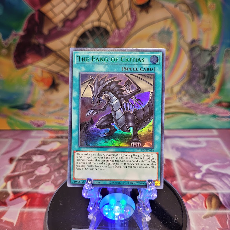 An Ultra Rare Green "The Fang of Critias" card from the Yugioh Set: Dragons of Legend: The Complete Series.