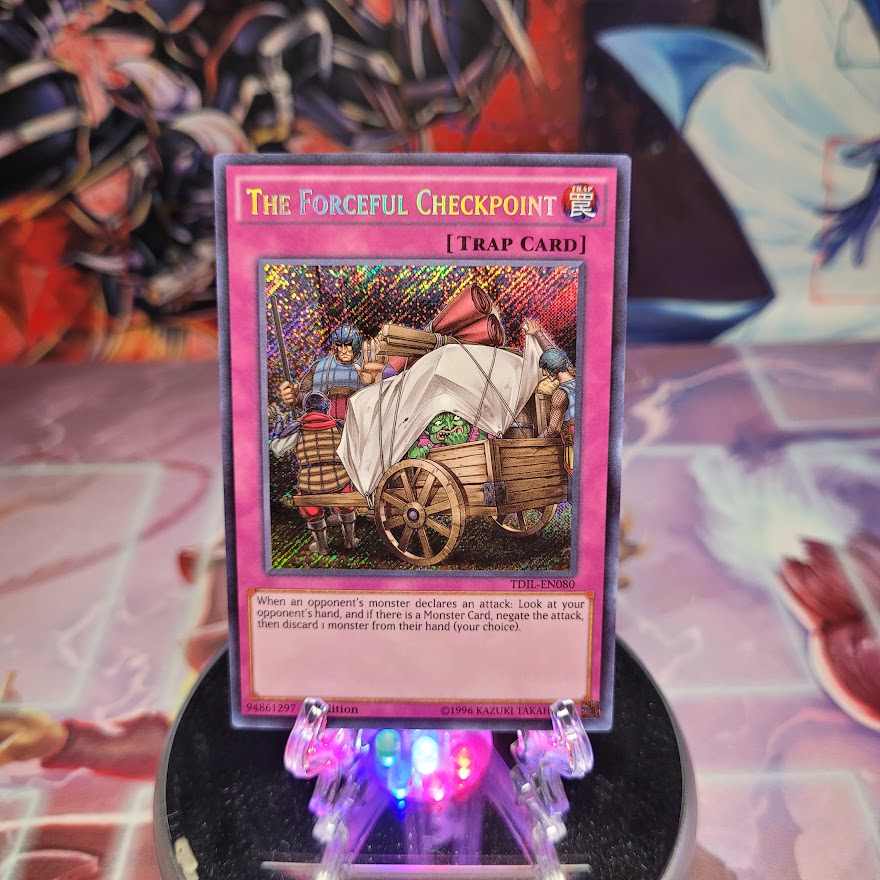 A Secret Rare "The Forceful Checkpoint" card from the Yugioh Set: The Dark Illusion (TDIL).