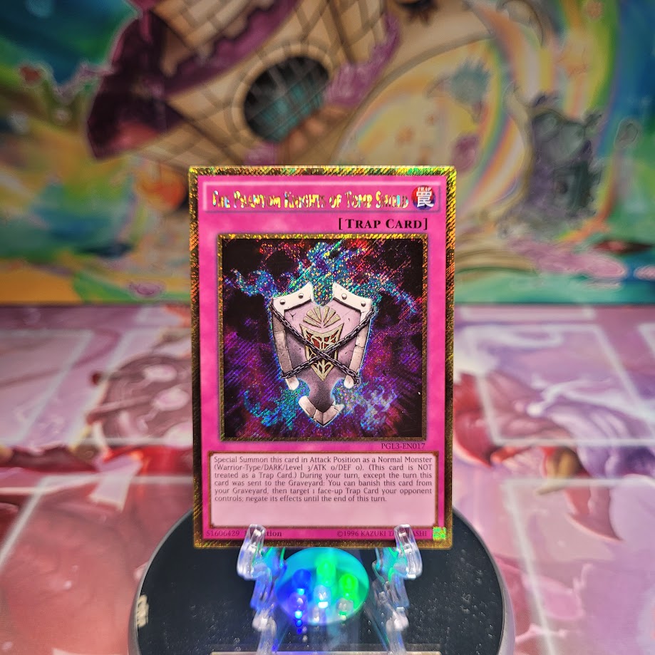 A Gold Secret Rare "The Phantom Knights of Tomb Shield" card from the Yugioh Set: Premium Gold: Infinite Gold (PGL3).
