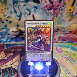 A Super Rare “The Three Champions of Swordsoul” card from the Yugioh Set: Chaos Origins (CORI).