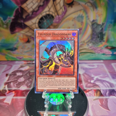 A Super Rare "Thunder Dragondark" card from the Yugioh Set: Quarter Century Bonanza (RA03).