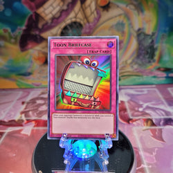 An Ultra Rare Green "Toon Briefcase" card from the Yugioh Set: Dragons of Legend: The Complete Series.