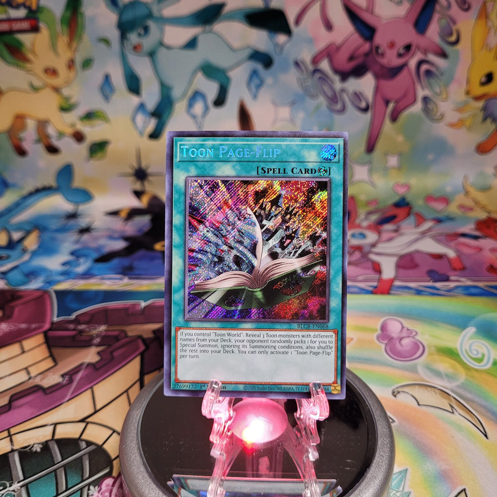 A Secret Rare "Toon Page-Flip" card from the Yugioh Set: Battles of Legend: Crystal Revenge (BLCR).