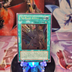 An Ultimate Rare "Tri-Blaze Accelerator" card from the Yugioh Set: Force of the Breaker.