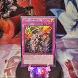 A Secret Rare "Tri-Brigade Revolt" card from the Yugioh Set: Rarity Collection 1 (RA01).