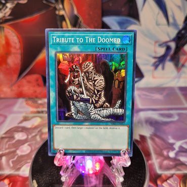 A Super Rare "Tribute to the Doomed" card from the Yugioh Set: Metal Raiders 25th Anniversary Edition.