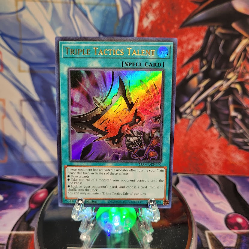 An Ultra Rare "Triple Tactics Talent" card from the Yugioh Set: Magnificent Mavens (MAMA).
