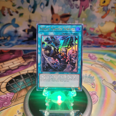 An Ultra Rare "Triple Tactics Thrust" card from the Yugioh Structure Deck: The Fallen & The Virtuous (CH01).