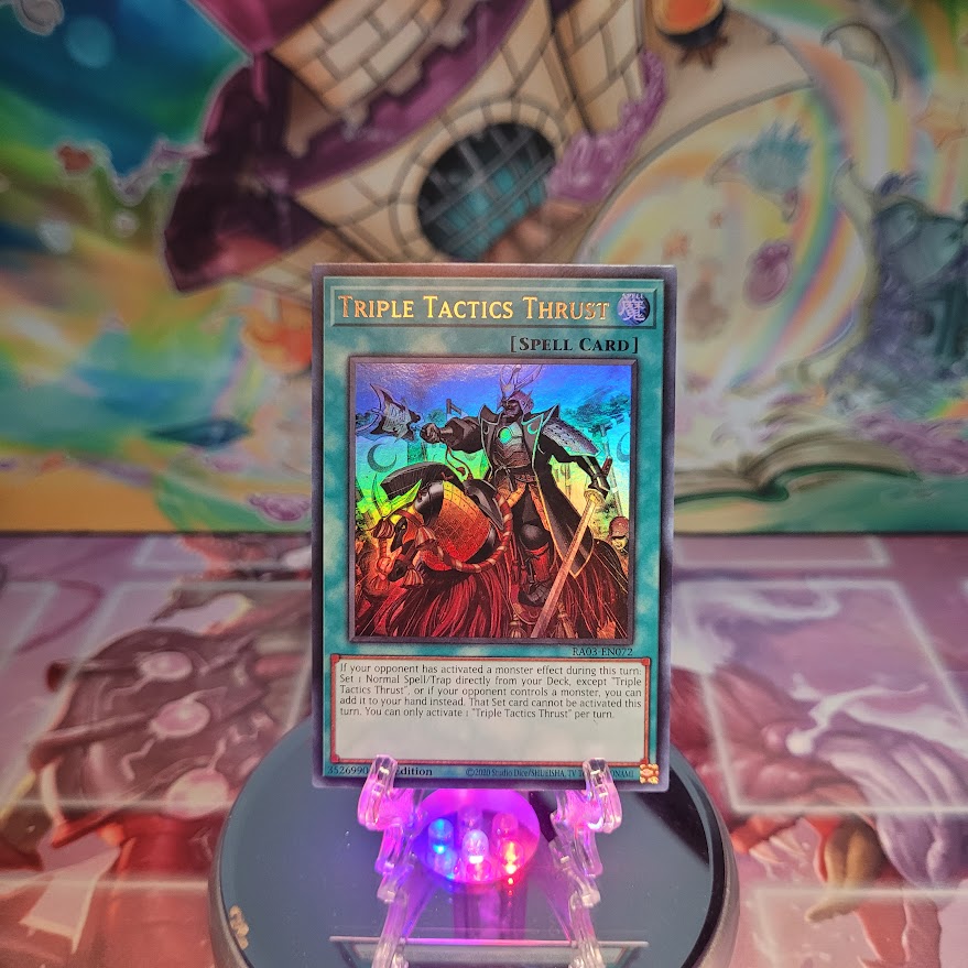 An Ultra Rare "Triple Tactics Thrust" card from the Yugioh Set: Quarter Century Bonanza (RA03).