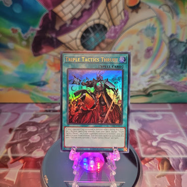 An Ultra Rare "Triple Tactics Thrust" card from the Yugioh Set: Quarter Century Bonanza (RA03).