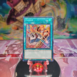 A Prismatic Secret Rare Alternate Art "Tuning" card from the Yugioh 25th Anniversary: Dueling Mirrors Tin (MP24).