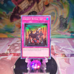 A Super Rare "Urgent Ritual Art" card from the Yugioh Set: Shadows in Valhalla.