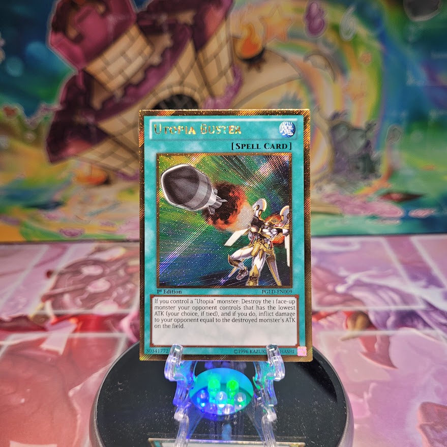 A Gold Secret Rare "Utopia Buster" card from the Yugioh Set: Premium Gold.