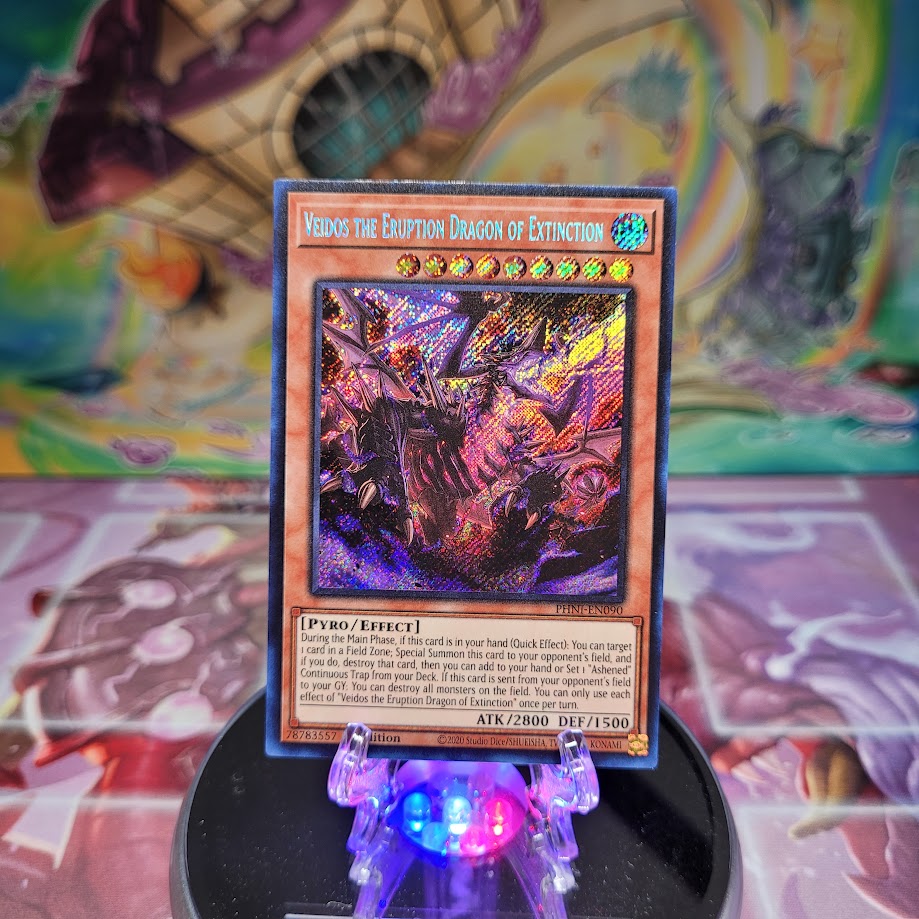 A Secret Rare "Veidos, the Eruption Dragon of Extinction" card from the Yugioh Set: Phantom Nightmare.