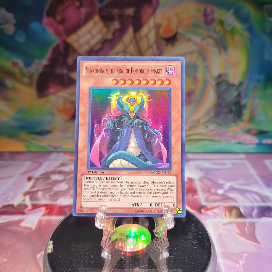 A Super Rare "Vennominon the King of Poisonous Snakes" card from the Yugioh Set: Legendary Collection 2.