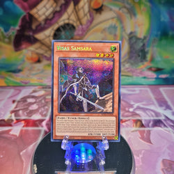 A Prismatic Secret Rare "Visas Samsara" card from the Yugioh 25th Anniversary: Dueling Mirrors Tin.