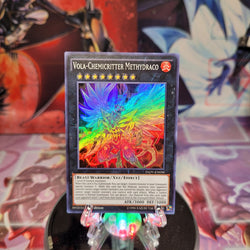 A Super Rare "Vola-Chemicritter Methydraco" card from the Yugioh Set: invasion: Vengeance (INOV).