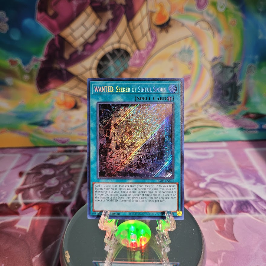 A Secret Rare "Wanted: Seeker of Sinful Spoils" card from the Yugioh Set: Quarter Century Bonanza (RA03).