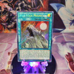 A Secret Rare "War Rock Mountain" card from the Yugioh Set: Blazing Vortex (BLVO).