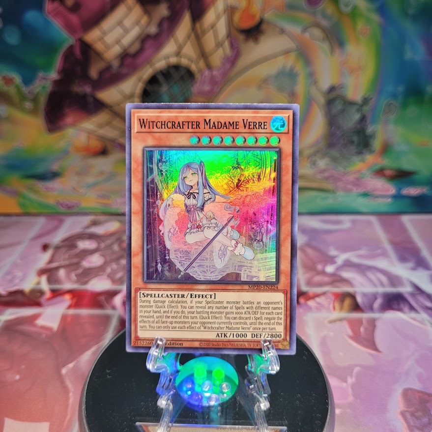 A Super Rare "Witchcrafter Madame Verre" card from the Yugioh 2020 Tin of Lost Memories.