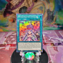 A Super Rare "Witchcrafter Unveiling" card from the Yugioh Set: Eternity Code.