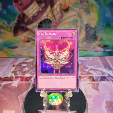 A Super Rare "Xyz Reborn" card from the Yugioh Set: Wing Raiders.